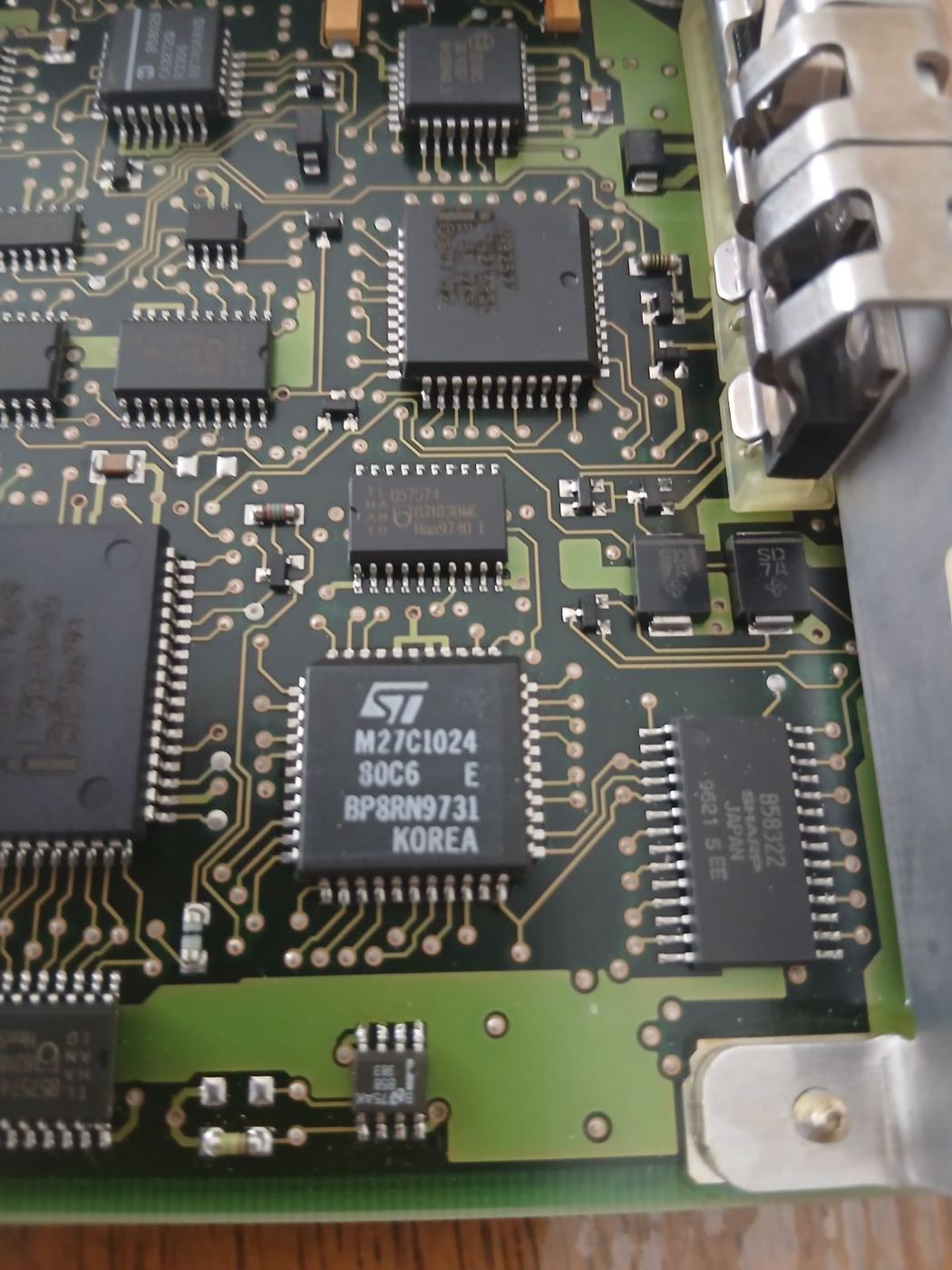 Close-up of a classic ECU circuit board with an M27C1024 EPROM chip